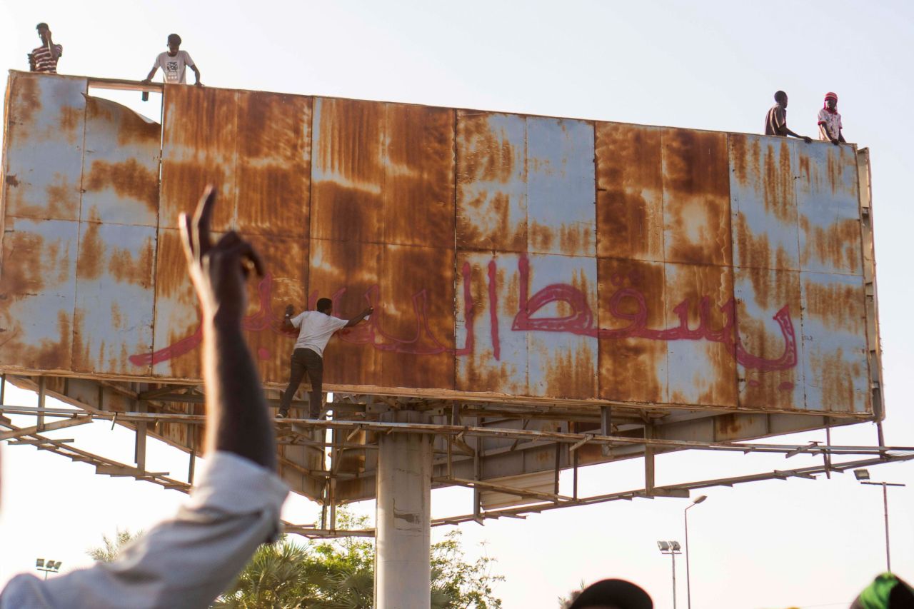 A person writes "Down with Bashir" during an April 9 demonstration in Khartoum.