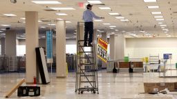A worker removes sale banners inside a closed Sears department store one day after it closed as part of multiple store closures by Sears Holdings Corp in the United States in Nanuet, New York, U.S., January 7, 2019. REUTERS/Mike Segar