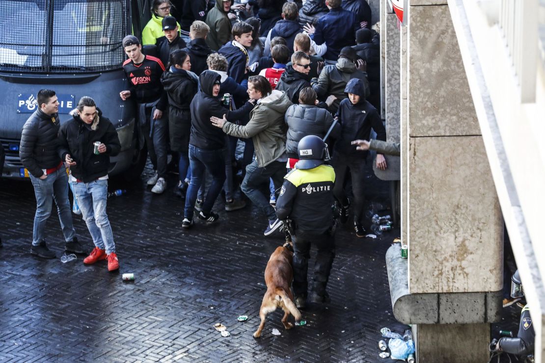 Dutch police officers surround Ajax's supporters ahead of the match. 