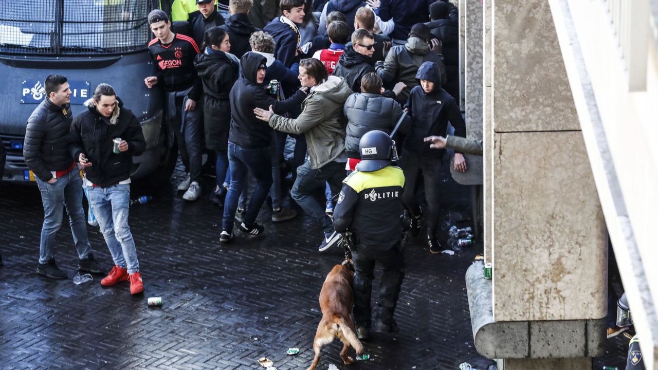 Dutch police officers surround Ajax's supporters ahead of the match.