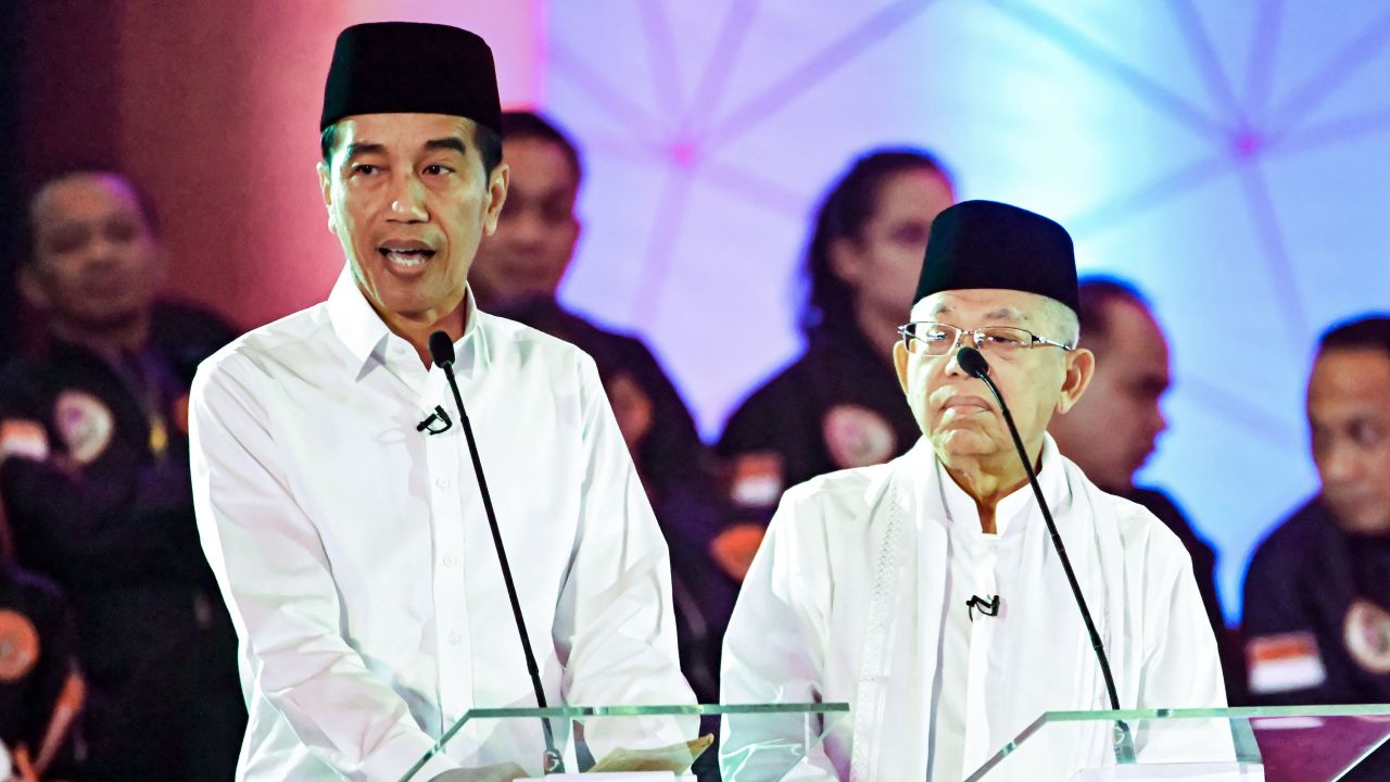 Presidential candidate incumbent President Joko Widodo, left, and his running mate Ma'ruf Amin, right, speak during a live nationwide television debate in Jakarta on January 17, 2019.