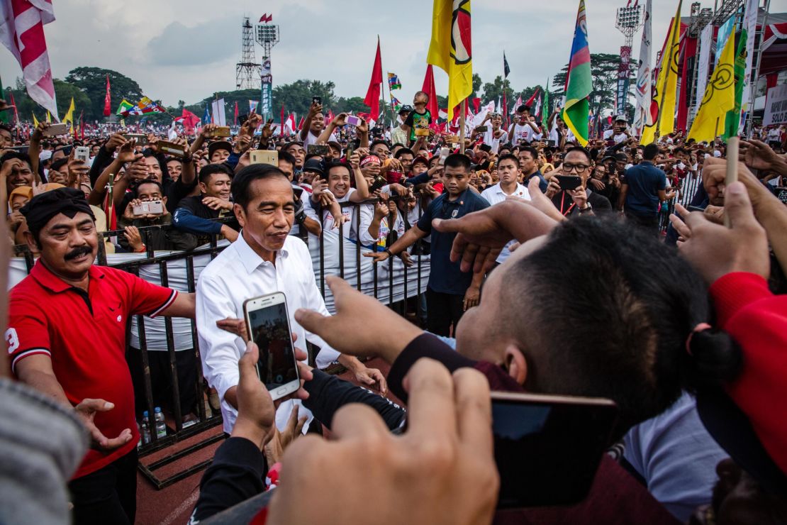 Indonesian incumbent Presidential candidate Joko Widodo, is greeted by his supporters at the Sriwedari stadium during an election campaign rally on April 9, 2019 in Solo, Central Java, Indonesia. 