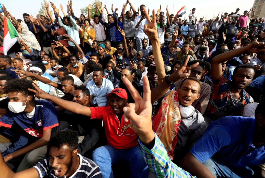 Protesters cheer outside the Defense Ministry in Khartoum on April 11. They were demanding that Bashir step down.