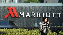 This photo taken on January 11, 2018 shows a woman walking past Marriott signage in Hangzhou in China's Zhejiang province.Authorities in China have shut down Marriott's local website for a week after the US hotel giant mistakenly listed Chinese-claimed regions such as Tibet and Hong Kong as separate countries. / AFP PHOTO / - / China OUT        (Photo credit should read -/AFP/Getty Images)