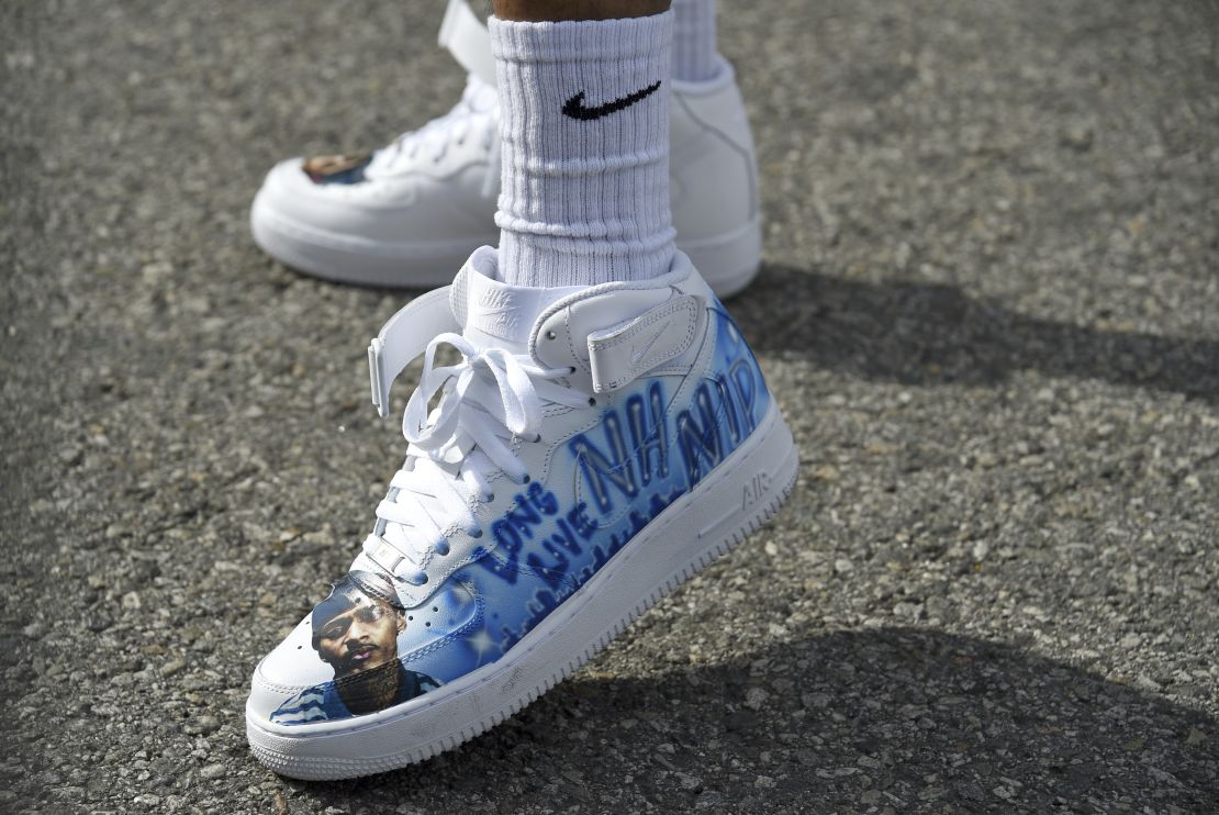 A resident of the Crenshaw neighborhood of Los Angeles wore shoes in tribute to Nipsey Hussle. 