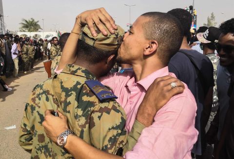 A protester kisses a soldier on the head during a rally in Khartoum on April 11.