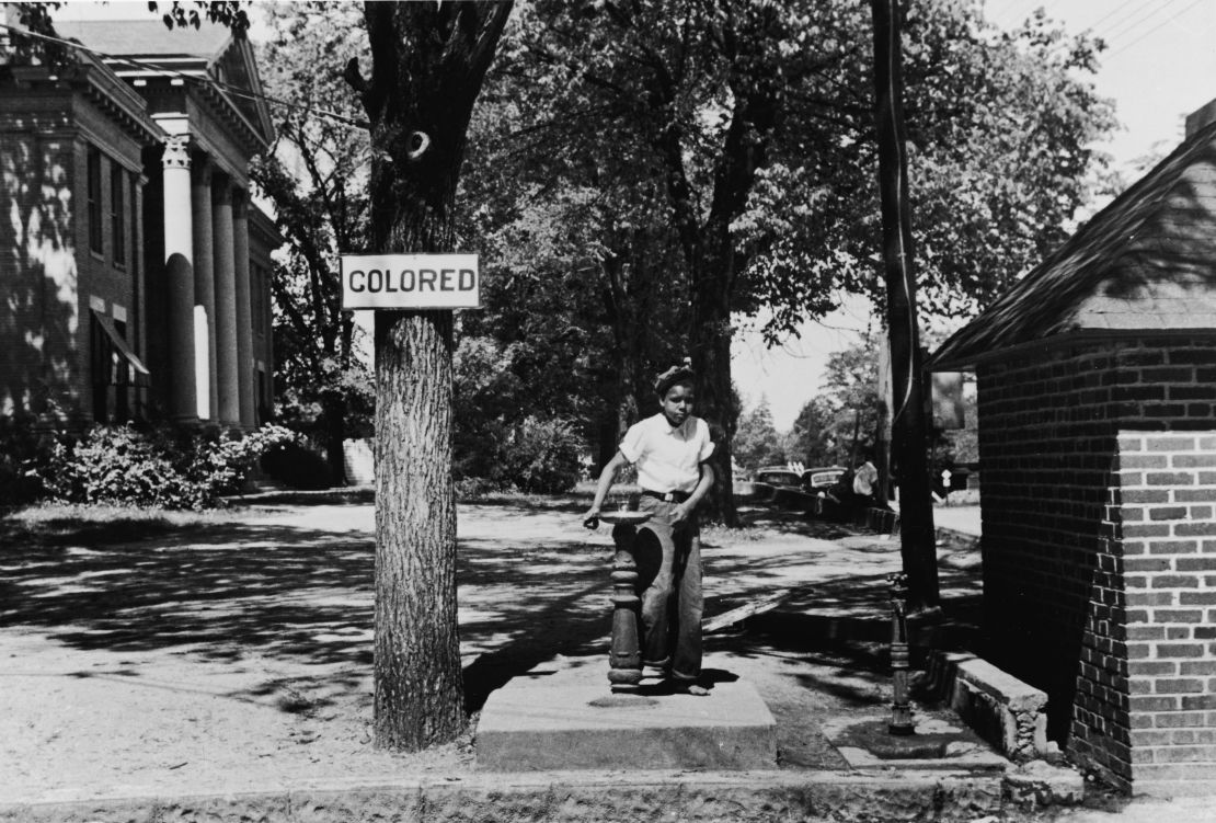 A young boy drinks from the "colored" water fountain on the county courthouse lawn in Halifax, North Carolina, in 1938. 
