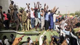 Sudanese anti-regime demonstrators stand on an army armoured military vehicle on April 11, 2019 as they cheer and flash the sign of victory in the area around the army headquarters where protesters have held an unprecedented sit-in now in its sixth day in Sudan's capital Khartoum to call on their president to step down. - The Sudanese army is planning to make "an important announcement", state media said today, after months of protests demanding the resignation of longtime leader President Omar al-Bashir. Thousands of Khartoum residents chanted "the regime has fallen" as they flooded the area around the military headquarters.