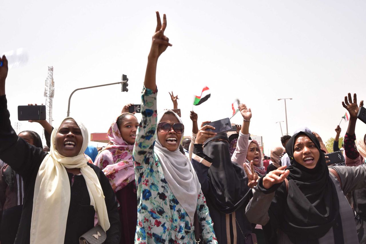 Demonstrators chant slogans as they gather in a street in central Khartoum.