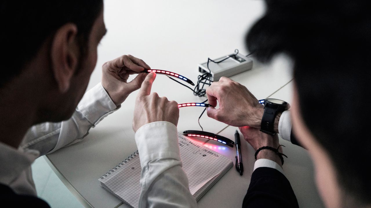 De Simone and Ferrari's engineers discuss the ideal level of brightness for the colored LED lights that go on the steering wheel.