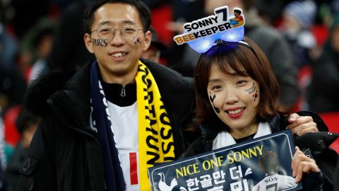 Two fans of Tottenham Hotspur's South Korean striker Son Heung-Min await their hero.