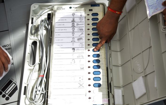 An electronic voting machine shows party symbols alongside candidates' names.