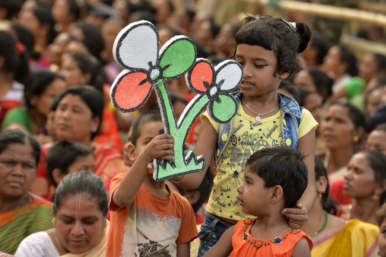 A child holds a symbol of the Trinamool Congress (TMC) party at an election campaign rally on April 5, 2019.