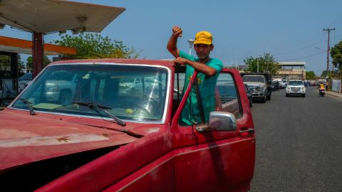 Hinginio Acosta has been pushing his truck through a line of cars, waiting three hours to refill his tank at a gas station in Cabimas.