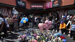 Fans pay their respects at a makeshift memorial outside The Marathon clothing store owned by Grammy-nominated rapper Nipsey Hussle where he was fatally shot along with 2 other wounded in Los Angeles, California on April 1, 2019. - The Grammy-nominated rapper found minor commercial success but was highly revered among his peers, and his shock death triggered an outpouring of tributes from hip hop royalty. (Photo by Mark RALSTON / AFP)        (Photo credit should read MARK RALSTON/AFP/Getty Images)
