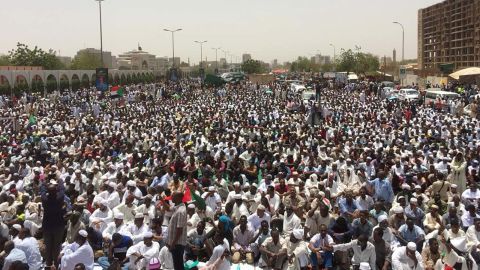 Sudanese protesters gather near the military headquarters in Khartoum as they continue to rally demanding a civilian body to lead the transition to democracy one day after a military council took control of the country, on April 12, 2019.