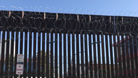 A section of the border fence with razor wire in Nogales, Arizona, looking south into Mexico.