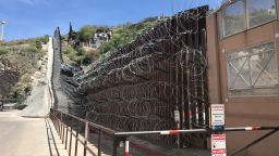 Rolls of concertina razor wire, installed by the US military at the request of DHS, drape the border fence stretching east from a pedestrian crossing between Nogales, Ariz., and Nogales, Sonora. April 10, 2019.