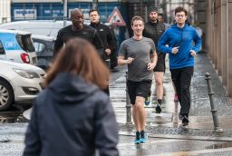 Facebook's Mark Zuckerberg runs with bodyguards in Germany in 2016.