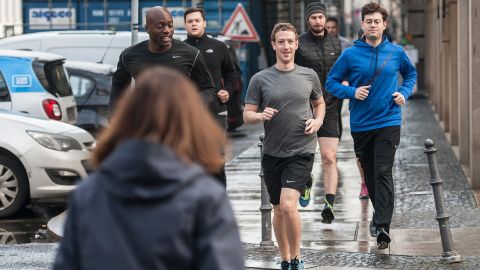 Facebook's Mark Zuckerberg runs with bodyguards in Germany in 2016.