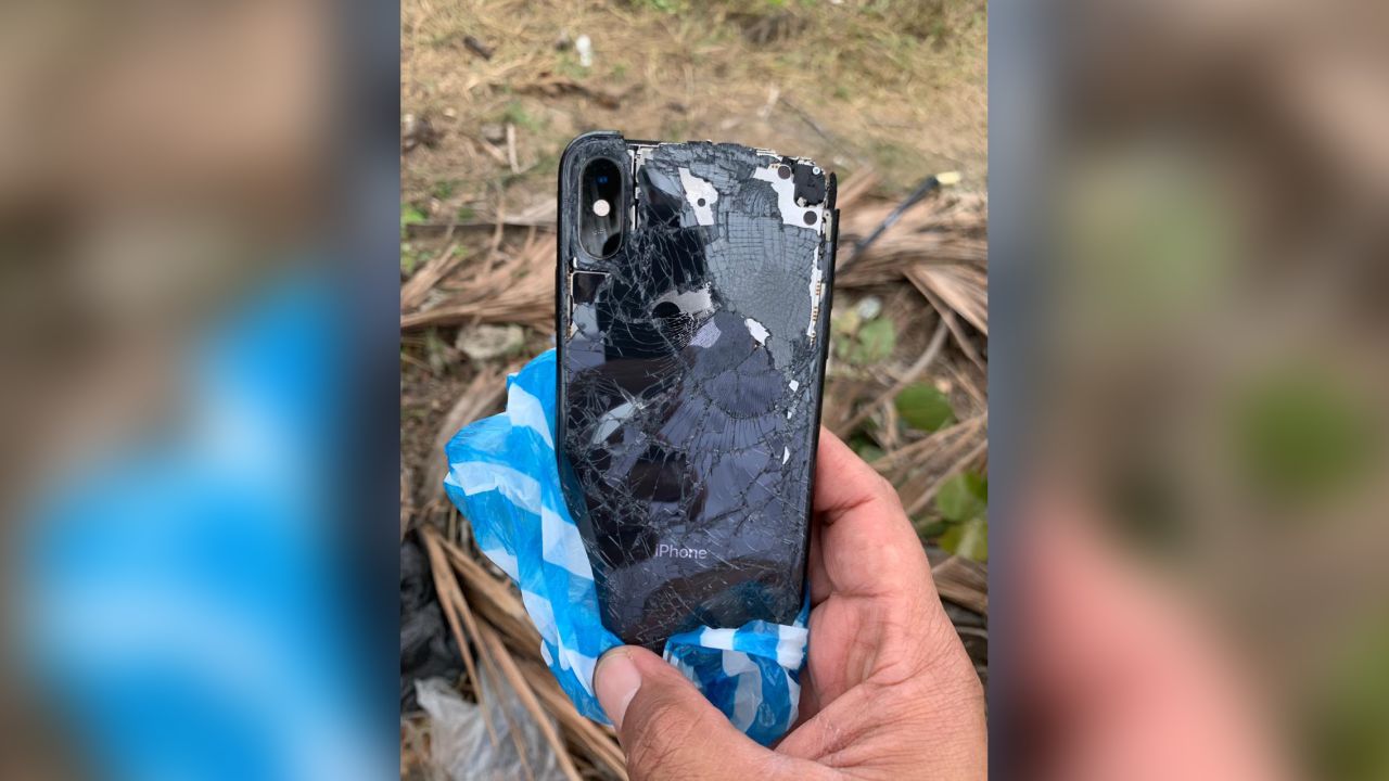 Searchers recover a black iPhone from the waters where the couple went missing.