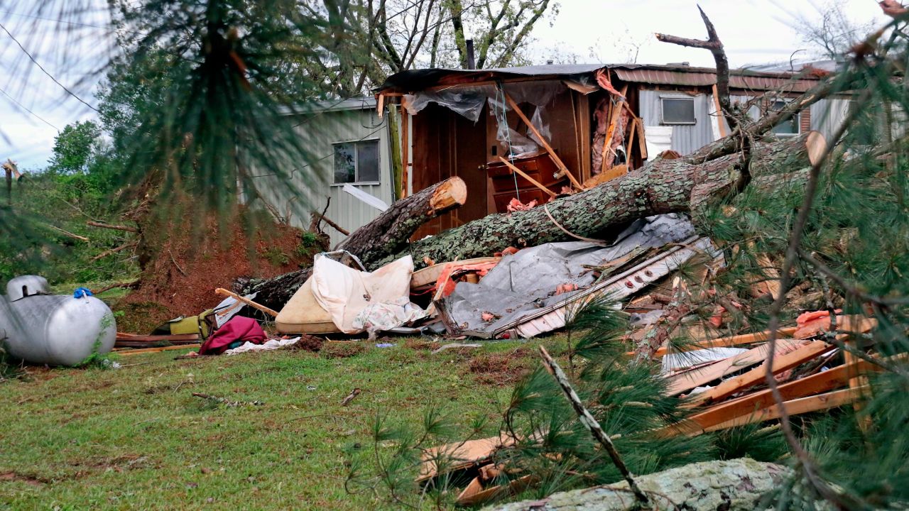 A pine tree lies across what remains of a trailer on Center Hill Road outside of Hamilton, Miss., after a deadly storm moved through the area Sunday, April 14, 2019.
