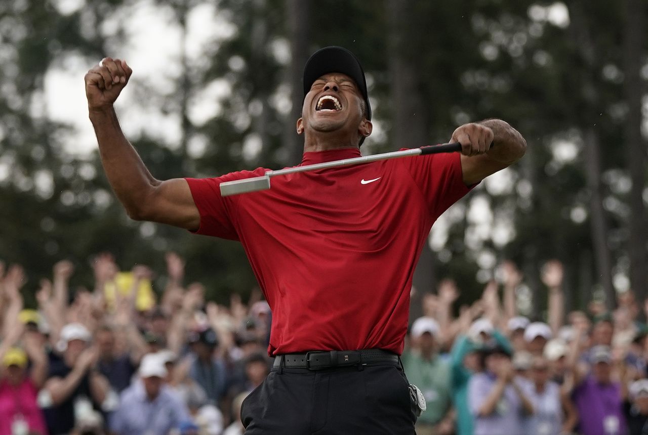 Tiger Woods punched the air to tumultuous applause and chants of "Tiger, Tiger" as he sealed his 15th major title.