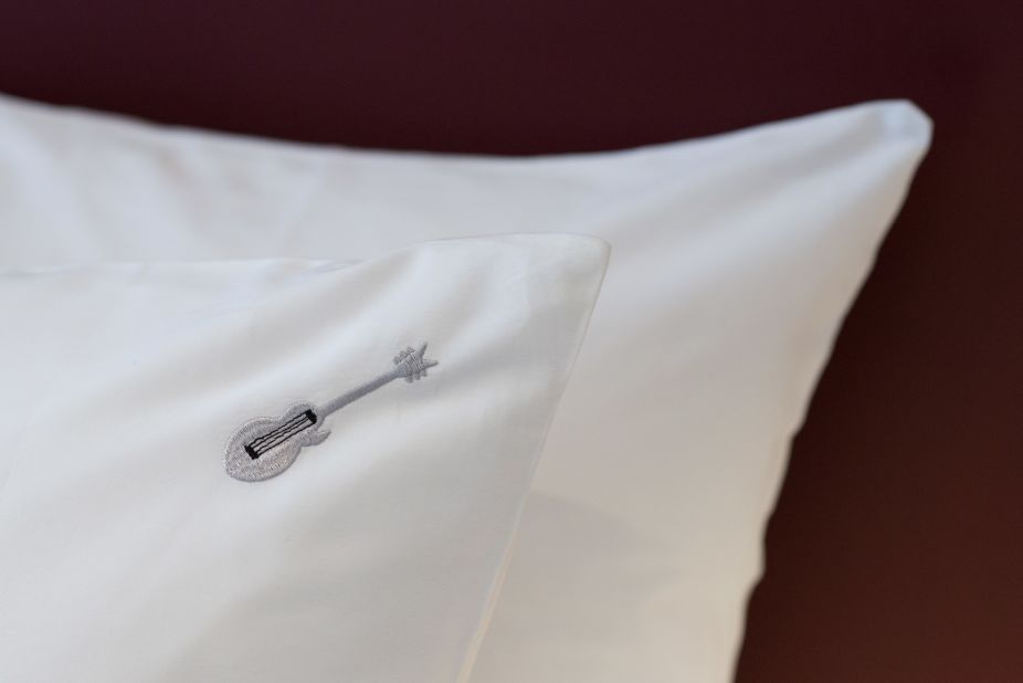<strong>Bedding: </strong>The hotel's bedding features rock-themed details, like this guitar-embroidered pillow case.