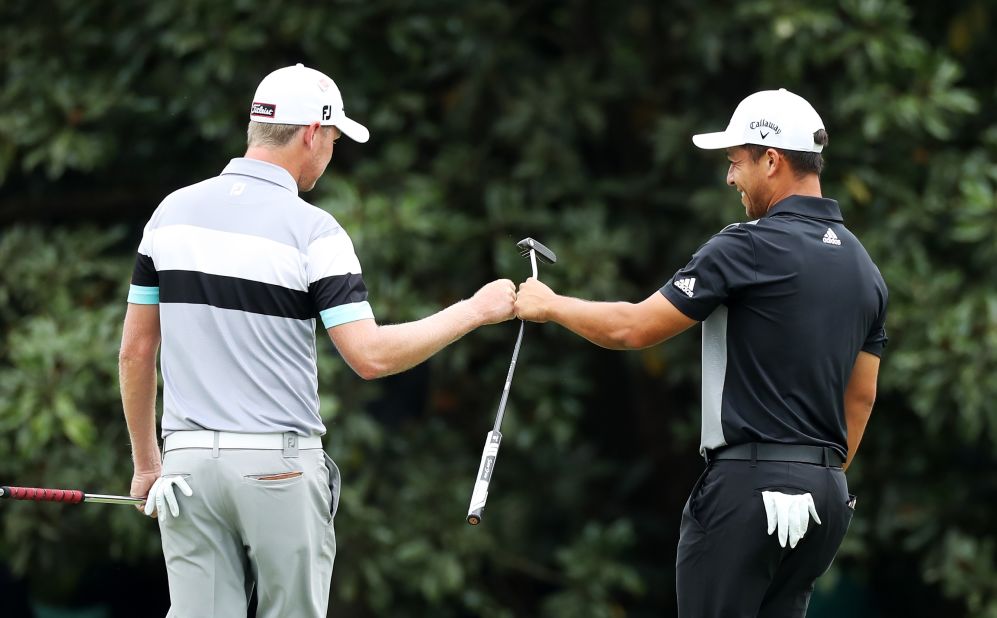 Alongside Woods chasing leader Francesco Molinari were Justin Harding (left) of South Africa and American Xander Schauffele.