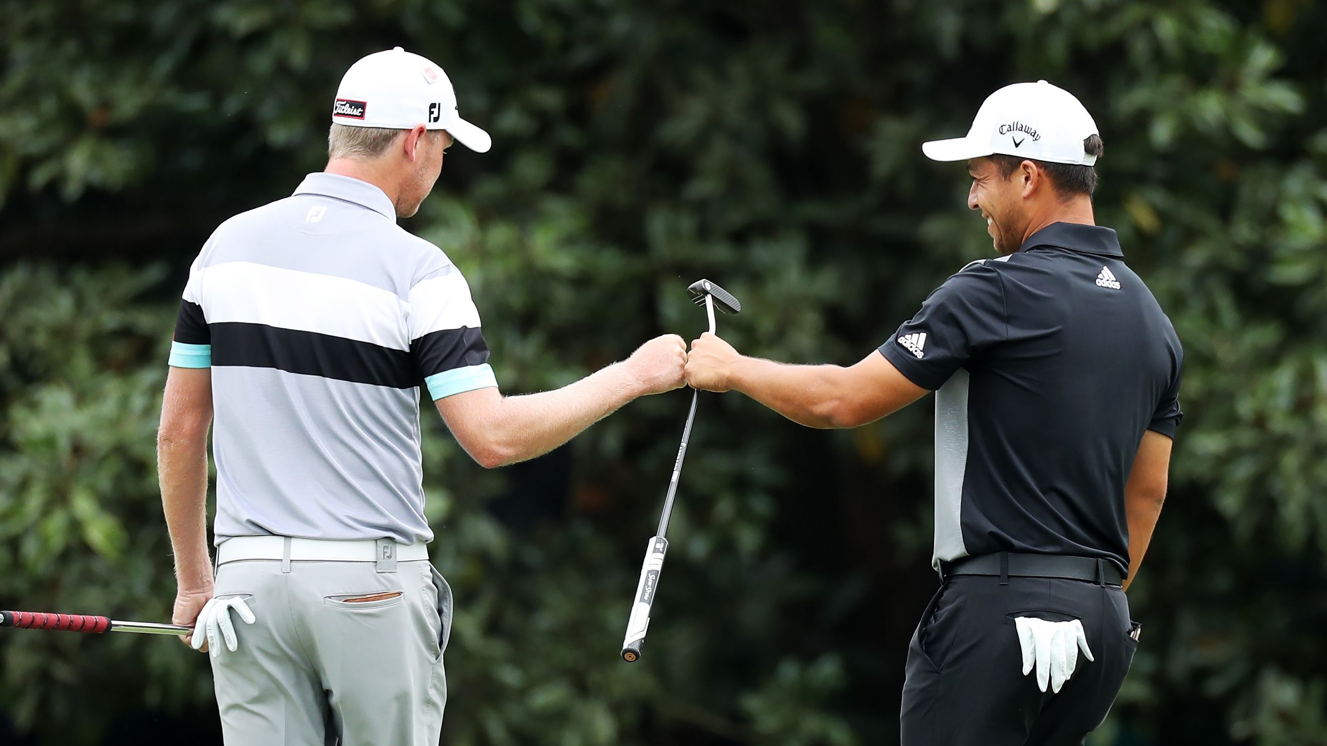 Alongside Woods chasing leader Francesco Molinari were Justin Harding (left) of South Africa and American Xander Schauffele.
