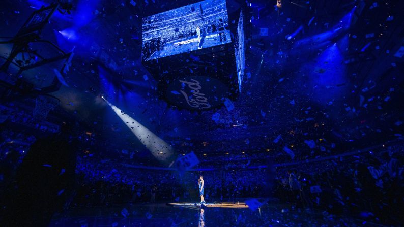 Retiring Dallas Mavericks forward Dirk Nowitzki says goodbye to fans amid lasers and confetti after a game against the Phoenix Suns at the American Airlines Center in Dallas.