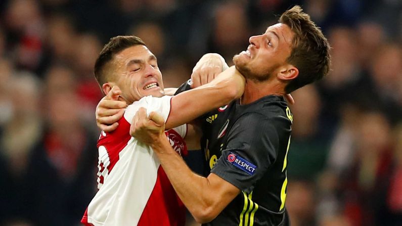 Ajax's Dusan Tadic clashes with Juventus' Daniele Rugani in Amsterdam on April 10. 
