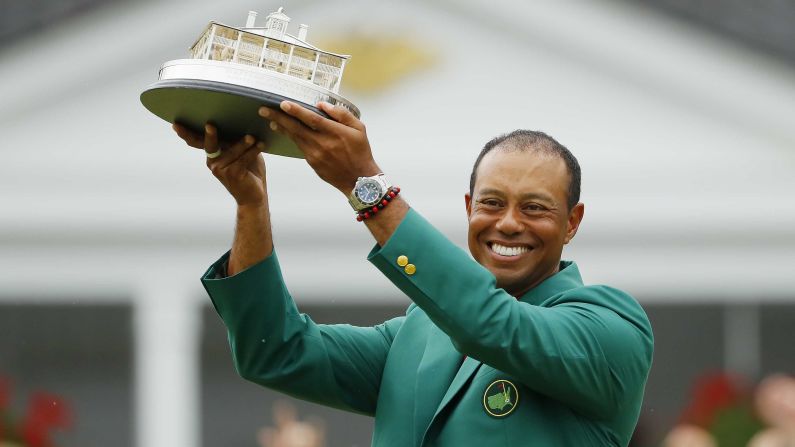 Tiger Woods of the United States celebrates with the Masters Trophy during the Green Jacket Ceremony after winning the Masters at Augusta National Golf Club on April 14 in Augusta, Georgia. 