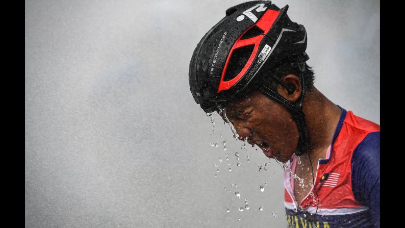 Malaysia's rider Muhammad Shahmir Aiman Abdul Halim cools off after crossing the finish line in Taiping during the fifth stage of the Malaysian Le Tour de Langkawi cycling race from Tanjung Malim to Taiping, on April 10.