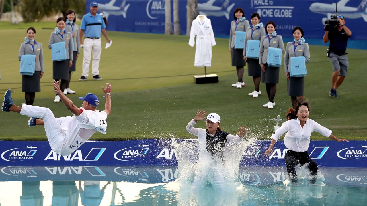 Ko Jin-young, her caddie David Brooker and her agent Choi Soo-jin leap into Poppie's Pond after her win in 2019.