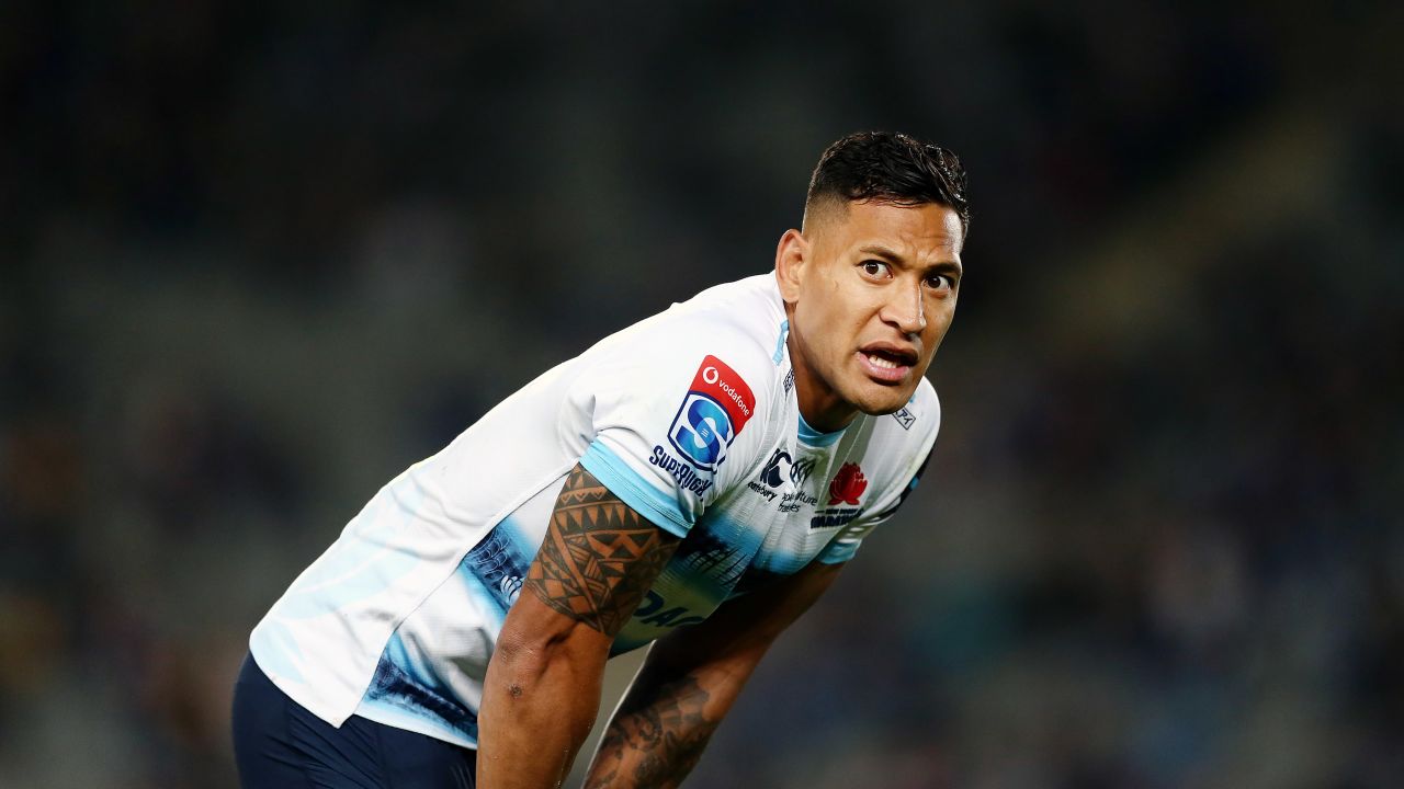 Folau of the Waratahs looks on.