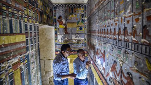 Mohamed Mujahid (L), head of the Egyptian mission which discovered the tomb of the ancient Egyptian nobleman "Khewi" dating back to the 5th dynasty (24942345 BC), inspects the tomb's walls inside at the Saqqara necropolis, about 35 kilometres south of the capital Cairo on April 13, 2019. (Photo by Mohamed el-Shahed / AFP)        (Photo credit should read MOHAMED EL-SHAHED/AFP/Getty Images)