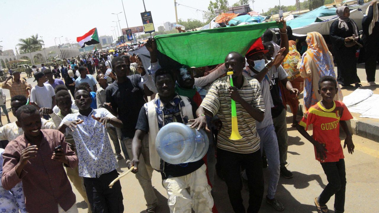 Sudanese protesters celebrate on April 13.
