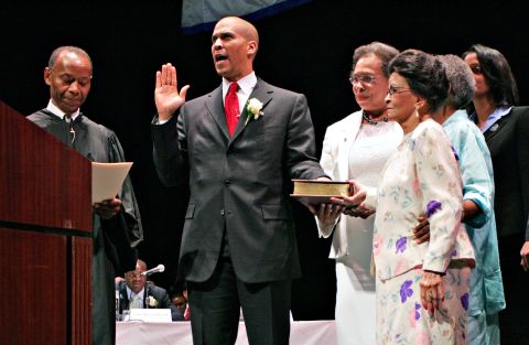 Booker takes the oath of office in July 2006. Next to him, holding the Bible, is his mother, Carolyn. Also holding the Bible in the foreground is Booker's grandmother, Adeline Jordan.
