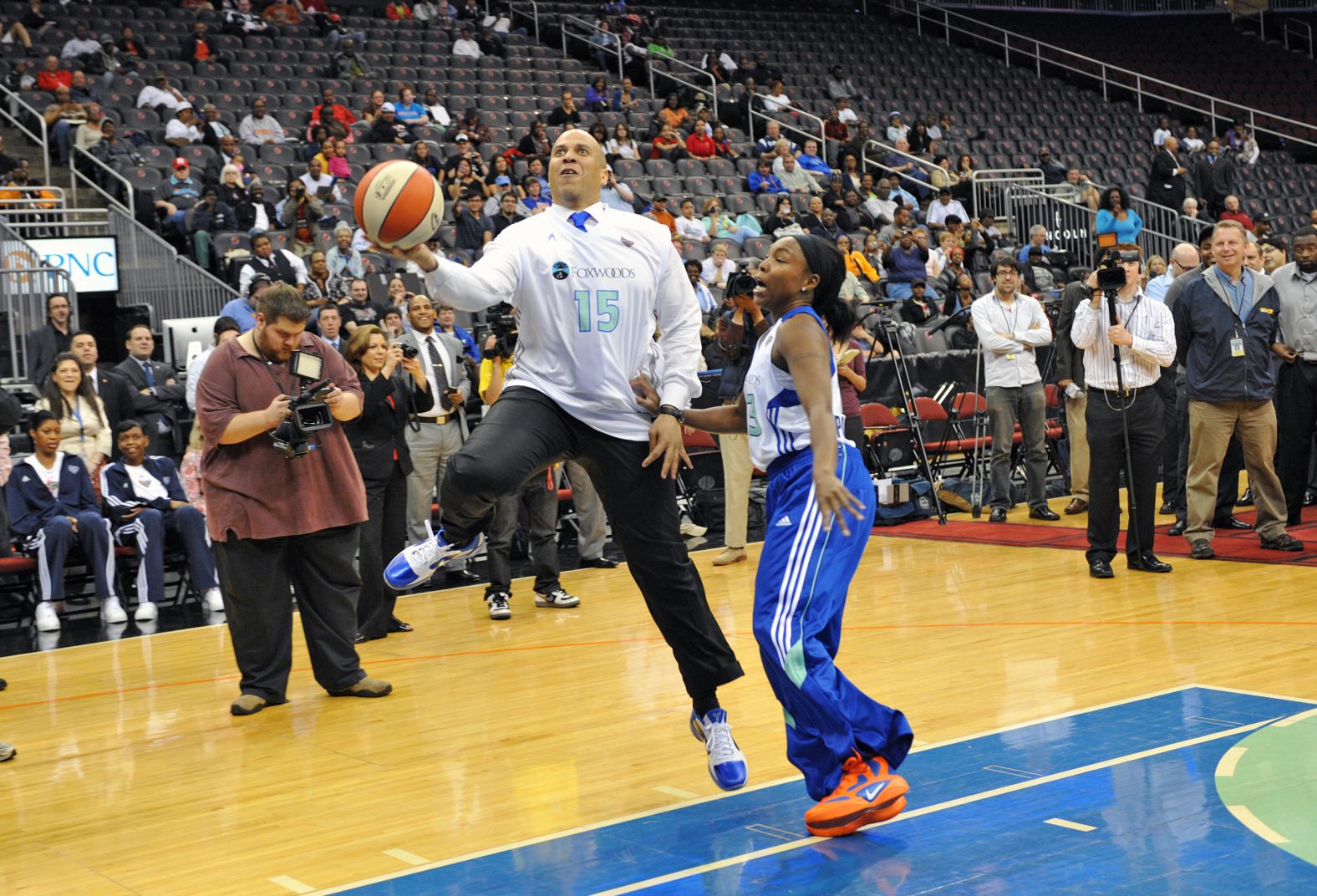 Booker plays a game of one-on-one with pro basketball player Cappie Pondexter in May 2011.