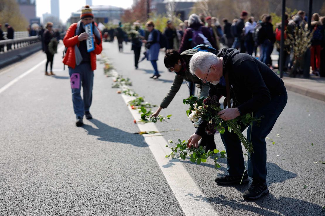 Protesters lay flowers on the road as they stage a demonstration on Waterloo Bridge.