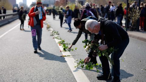 Protesters lay flowers on the road as they stage a demonstration on Waterloo Bridge.