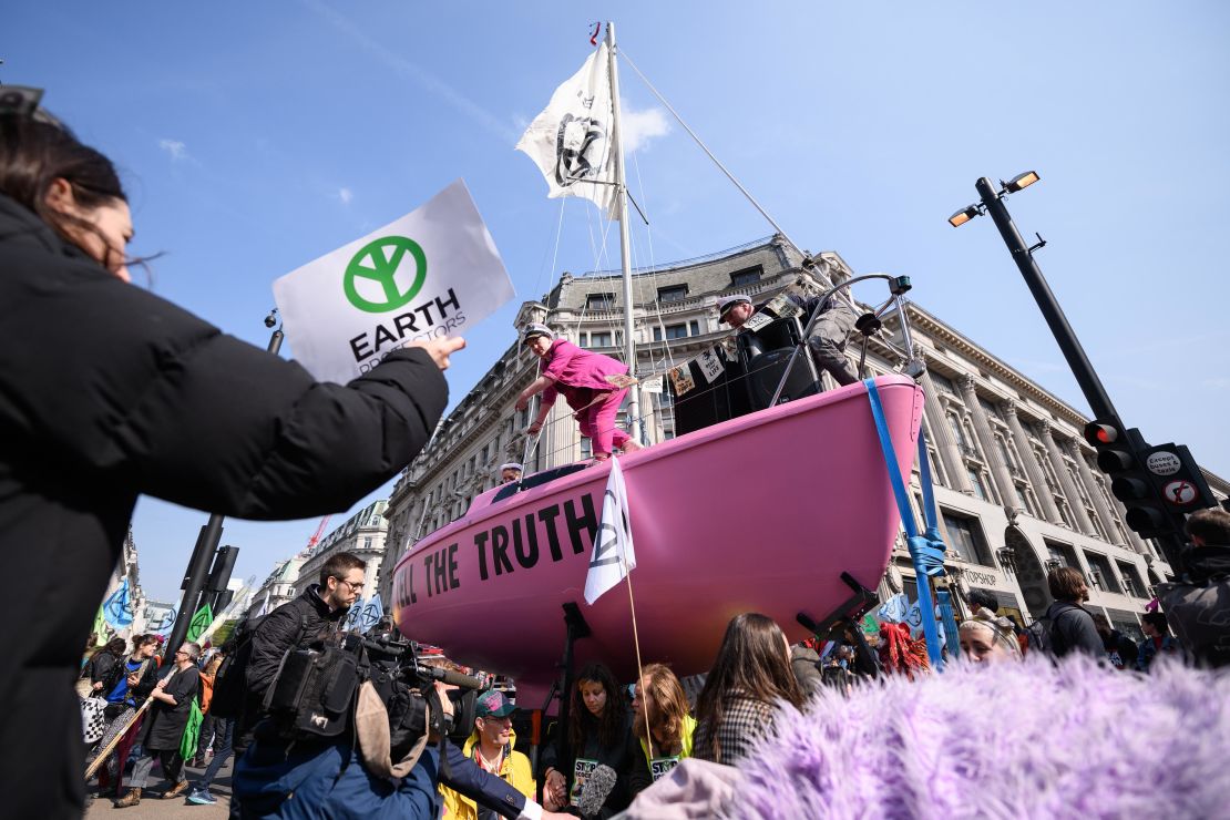 A pink sailboat with the message "TELL THE TRUTH" blocks Oxford Circus.
