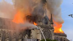 TOPSHOT - Flames and smoke are seen billowing from the roof at Notre-Dame Cathedral in Paris on April 15, 2019. - A fire broke out at the landmark Notre-Dame Cathedral in central Paris, potentially involving renovation works being carried out at the site, the fire service said.Images posted on social media showed flames and huge clouds of smoke billowing above the roof of the gothic cathedral, the most visited historic monument in Europe. (Photo by Patrick ANIDJAR / AFP)        (Photo credit should read PATRICK ANIDJAR/AFP/Getty Images)