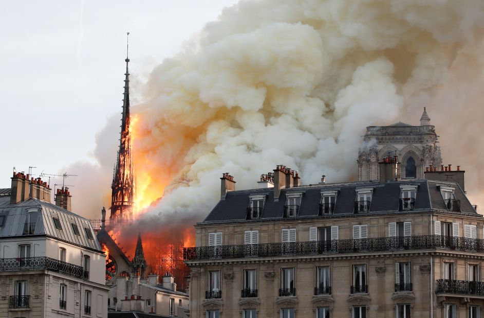 Huge clouds of smoke rise into the evening sky as fire engulfs the cathedral.