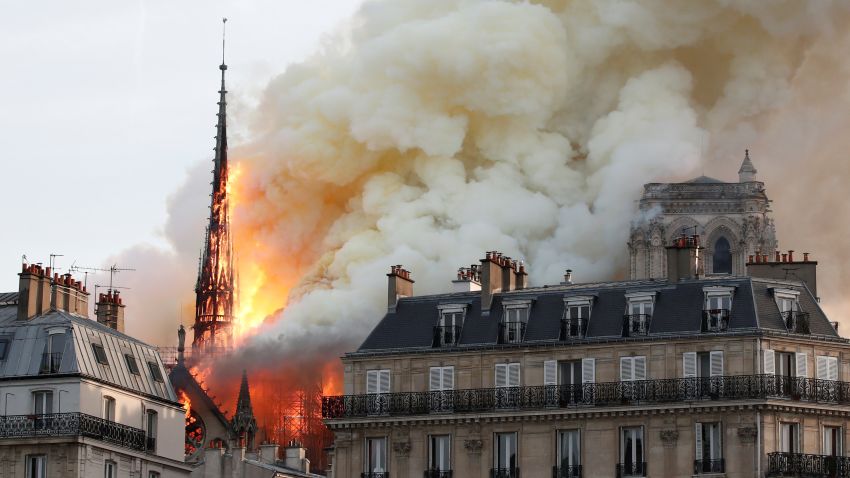 Smoke billows as fire engulfs the spire of Notre Dame Cathedral in Paris, France April 15, 2019. REUTERS/Benoit Tessier