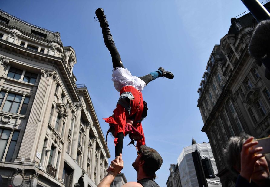 Acrobats participate in the demonstration at Oxford Circus on April 15.