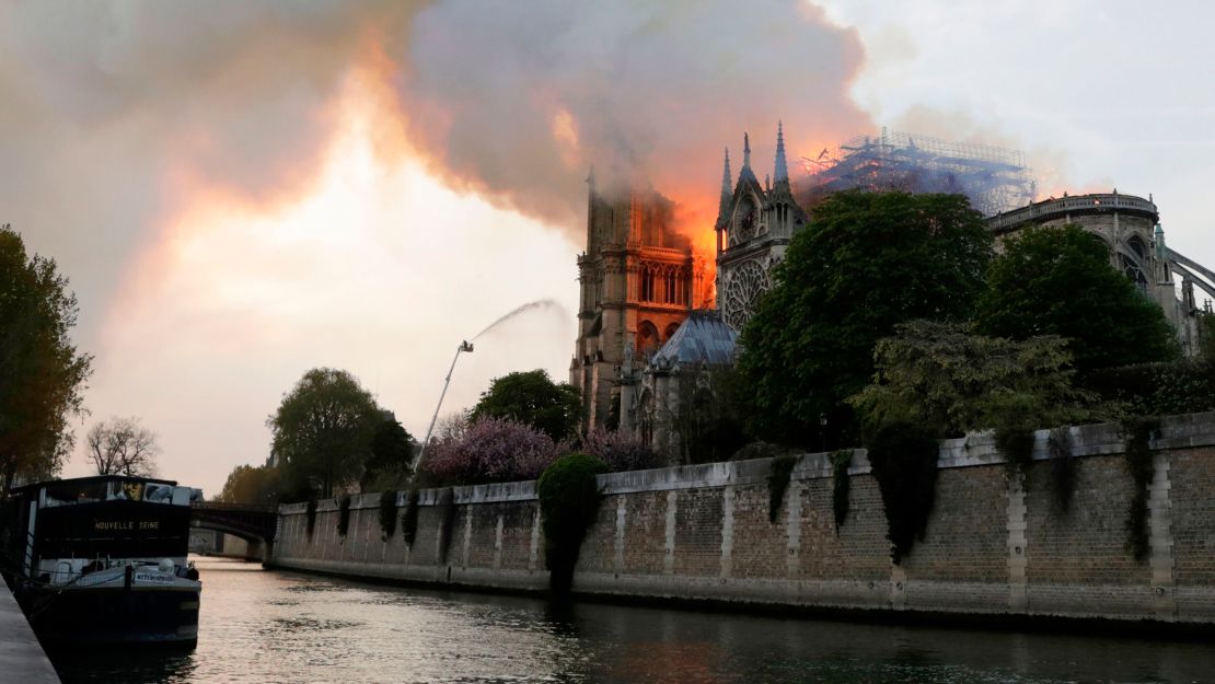 Flames and smoke are seen billowing from the roof of the Notre Dame.