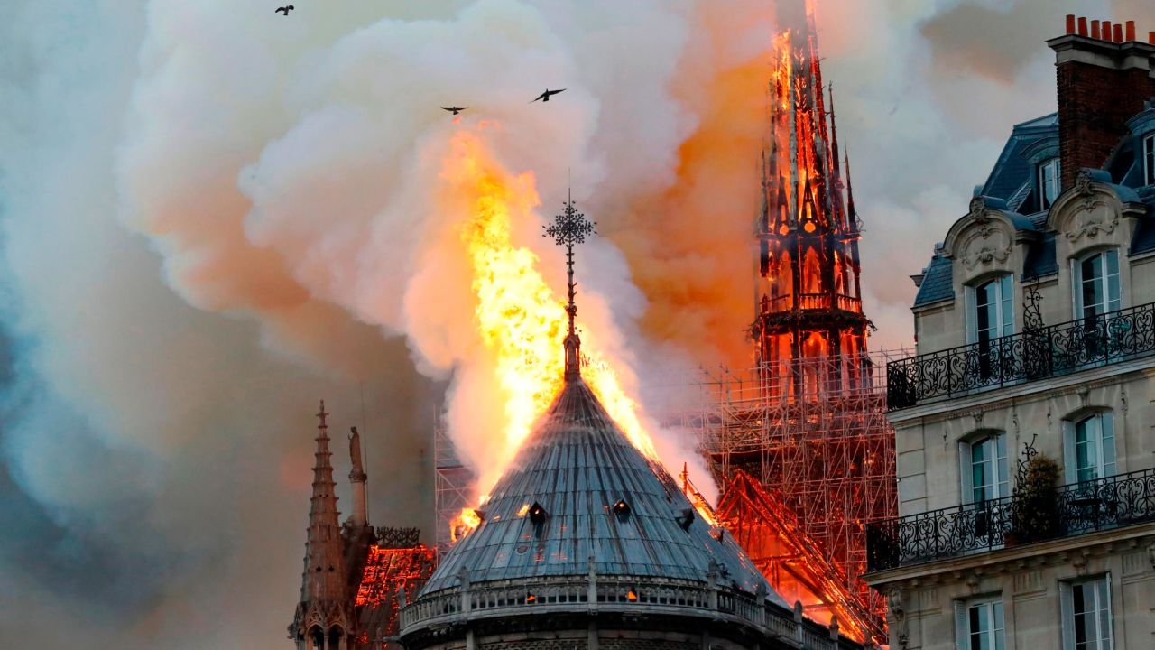 TOPSHOT - Smoke and flames rise during a fire at the landmark Notre-Dame Cathedral in central Paris on April 15, 2019, potentially involving renovation works being carried out at the site, the fire service said. (Photo by FRANCOIS GUILLOT / AFP)