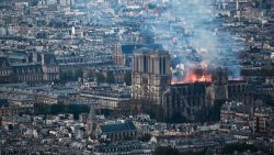 Smoke and flames rise during a fire at the landmark Notre-Dame Cathedral in central Paris on April 15, 2019, potentially involving renovation works being carried out at the site, the fire service said. - A major fire broke out at the landmark Notre-Dame Cathedral in central Paris sending flames and huge clouds of grey smoke billowing into the sky, the fire service said. The flames and smoke plumed from the spire and roof of the gothic cathedral, visited by millions of people a year, where renovations are currently underway. (Photo by Philippe LOPEZ / AFP)        (Photo credit should read PHILIPPE LOPEZ/AFP/Getty Images)